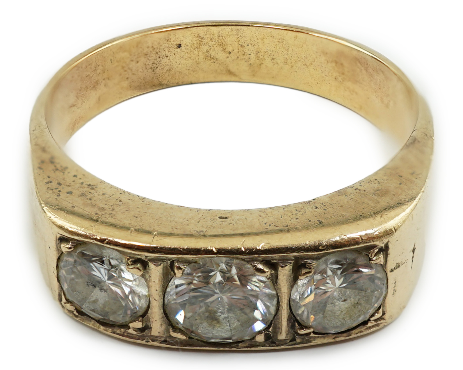 A gold and channel set three stone diamond ring